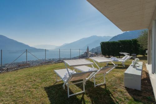 a couple of chairs and a table on a lawn at Valarin Luxury Apartments & Wellness, Vercana by Rent All Como in Vercana