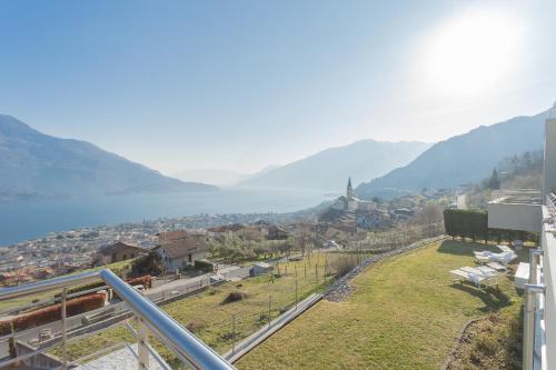a view from a balcony of a town with mountains at Valarin Luxury Apartments & Wellness, Vercana by Rent All Como in Vercana