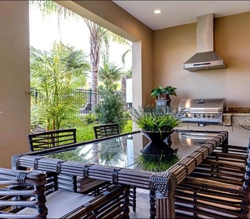 a patio with a table and chairs and a grill at Super Close to Disney Magic Stays in Orlando