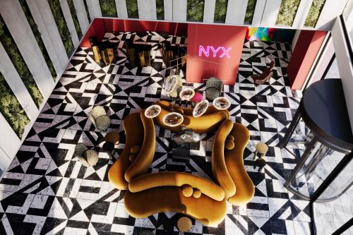 an overhead view of a magazine with chairs and glasses at NYX Hotel Thessaloniki in Thessaloniki