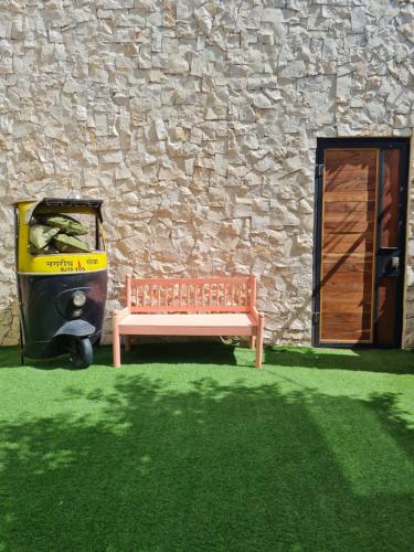 a bench sitting in front of a stone building with a door at La Bocania in Progreso