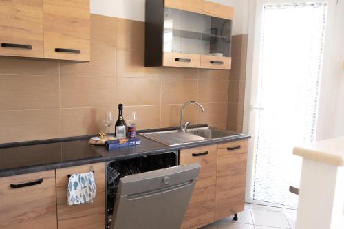 a kitchen with a sink and a dishwasher at CasaGiaco Verbania in Intra