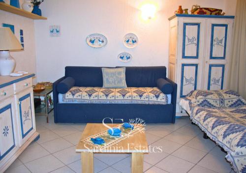 a living room with a couch and a table at Rainbow House - Fronte Spiaggia in Porto Rotondo