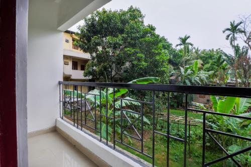 a balcony with a view of a garden at Treebo Urban Oasis Inn, Sixmile in Guwahati