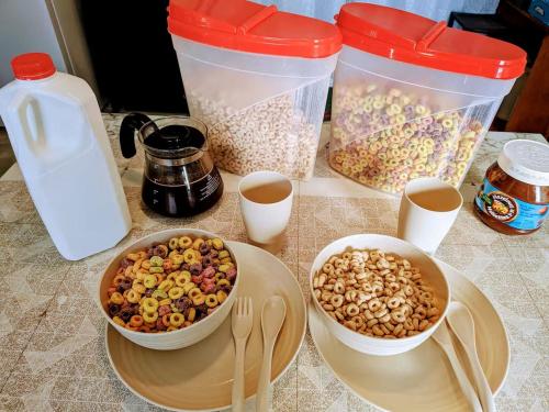 a table with two containers of food and bowls of nuts at 203 Quadruple Bed & Breakfast bedroom Downtown in Glace Bay