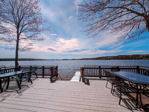 a dock with benches and a view of a lake at Back of the Moon Lakefront Camp family watersports fire pit 1 dog beach sleeps 8 in Sullivan