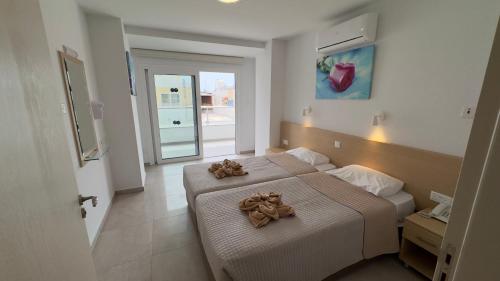 a bedroom with two beds with teddy bears on them at Christabelle Hotel Apartments in Ayia Napa