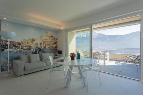 a living room with a table and a couch at Valarin Luxury Apartments & Wellness, Vercana by Rent All Como in Vercana