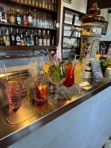 a bar with a bunch of different types of drinks at Hotel zur Post Dabringhausen in Wermelskirchen