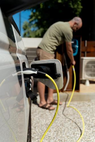 a man is washing a car with a yellow hose at Al Casale - Guest House in Sambruson