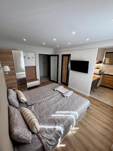 a bedroom with a large bed and a couch at Glavinitsa Luxury Suites, Главиница in Glavinitsa
