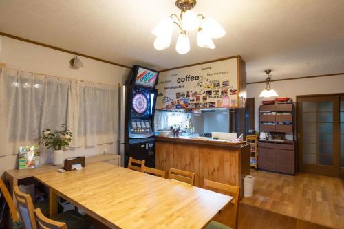 a dining room with a wooden table and a bar at 貸別荘MUSIC FOREST by MFR in Sasayama
