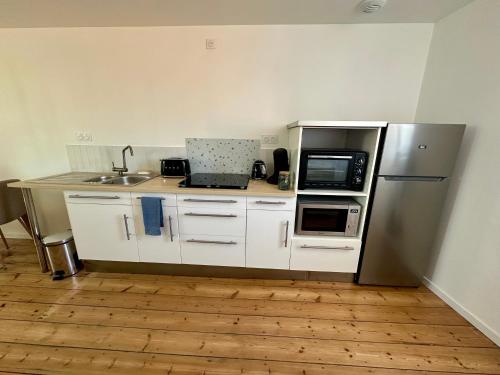 Kuchyň nebo kuchyňský kout v ubytování Le Duplex Appartement