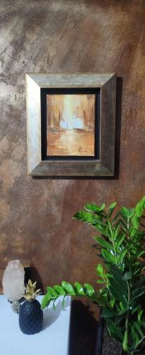 a picture frame hanging on a wall with a plant at Eye Luxury Penthouse in Sarandë