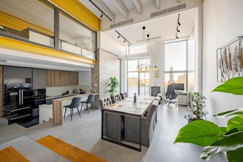 an open kitchen and living room with a table and chairs at Luxury Apartment with Pool in Xagħra