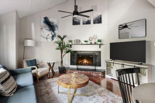a living room with a fireplace and a tv at Secret Gardens Fireplace Deck & Dog-Friendly in Inwood