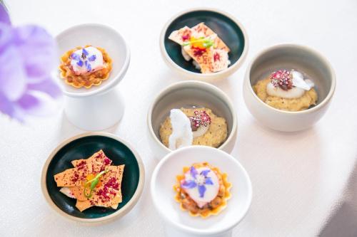 a group of bowls filled with different types of desserts at Blu Suite Resort in Bellaria-Igea Marina