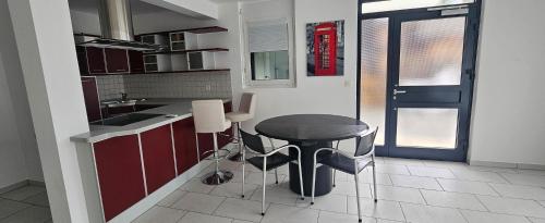 a kitchen with a black table and a counter at Ferienwohnung Bergweg in Termen