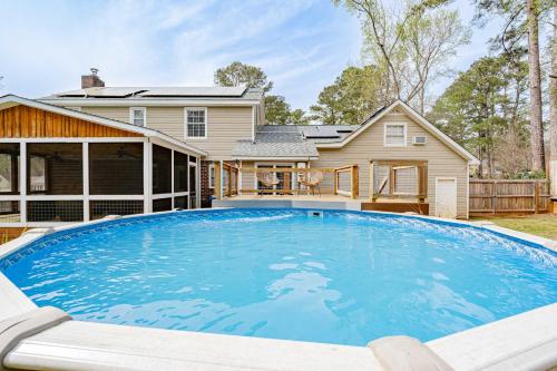 a large swimming pool in front of a house at Fenced Yard 10 Mins to Lake Murray in Columbia