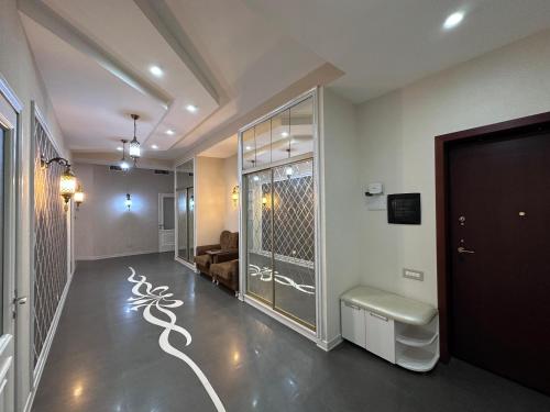 a living room with a hallway with a door and a couch at Saphire apartment by Bakuapart in Baku