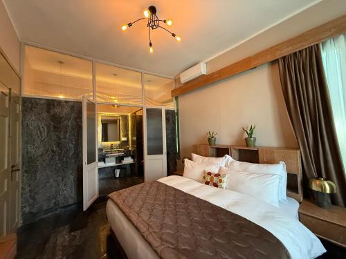 a bedroom with a large bed and a bathroom at Hotel Lost Ashrafieh in Beirut
