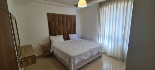 Ένα ή περισσότερα κρεβάτια σε δωμάτιο στο فورتاليزا للإسكان