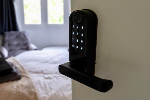 a remote control is attached to a wall at Single room in brand new 5 bedroom home BW Room 2 in Olton