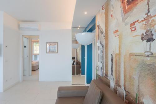 a living room with a couch and a painting on the wall at Valarin Luxury Apartments & Wellness, Vercana by Rent All Como in Vercana