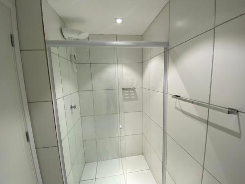 a shower with a glass door in a bathroom at Studio aconchegante- Japão liberdade in Sao Paulo