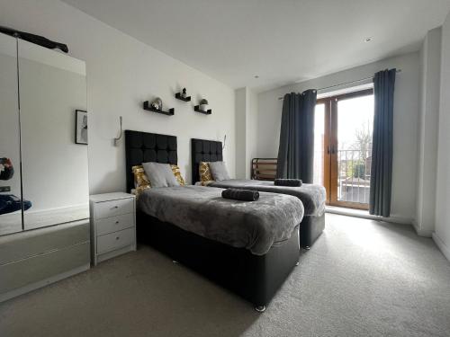 a bedroom with a large bed and a window at Grosvenor Rd - 2-Bedrooms - Sleeps 5 - Parking in Saint Albans