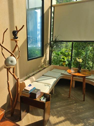 a living room with a couch and a table at Polkadot Hostel in Phitsanulok