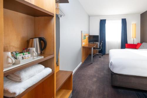 a hotel room with a bed and a desk at Holiday Inn Express Bedford by IHG in Bedford