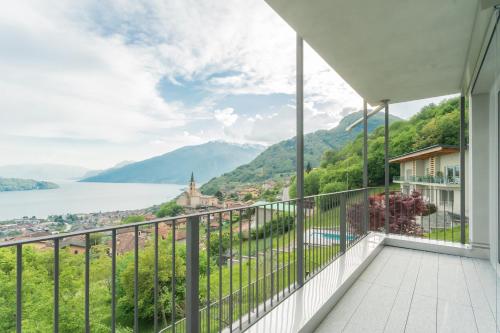 a balcony with a view of the lake and mountains at Valarin Luxury Apartments & Wellness, Vercana by Rent All Como in Vercana