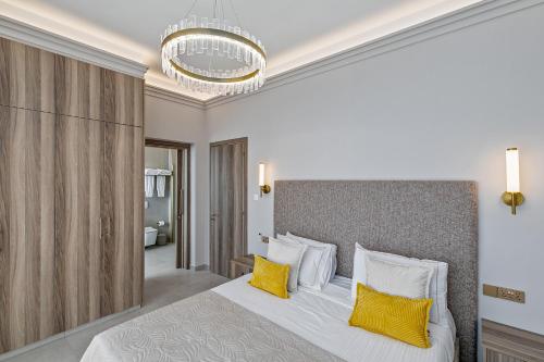 a bedroom with a large bed with yellow pillows at Olymp Luxury Family House in Paphos