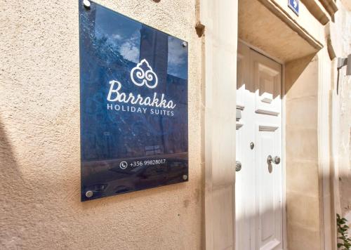 a sign on the side of a building at Barrakka Suites in Valletta