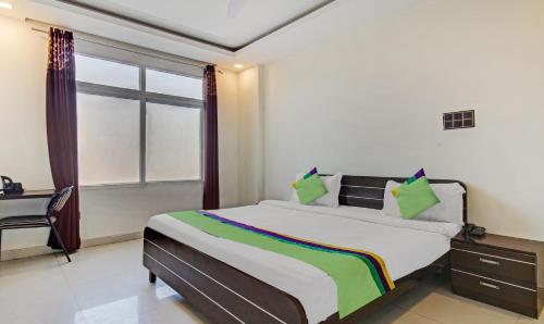 a bedroom with a bed with a desk and a window at Treebo Silver Grand in Lucknow
