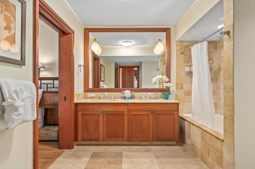 a bathroom with a sink and a mirror at Big Island Kolea 14H by Coldwell Banker Island Vacations in Waikoloa