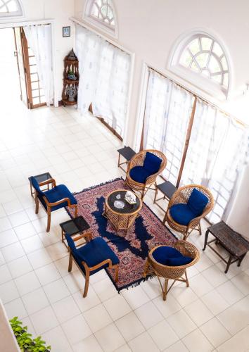 a living room with chairs and a table at Riverside Group in Kakkanad