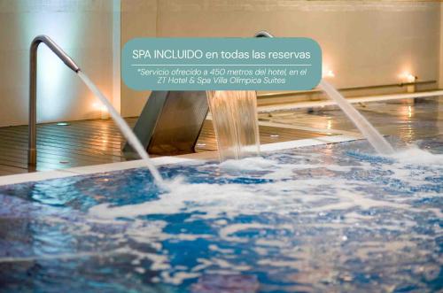 a hot tub with water coming out of it at Golden Hotel Barcelona in Barcelona
