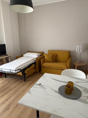 a living room with a bed and a couch at Verde Acqua Suite in Lecco