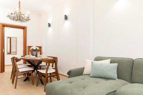 a living room with a couch and a table at MainAvenue Living Savoir in Thessaloniki