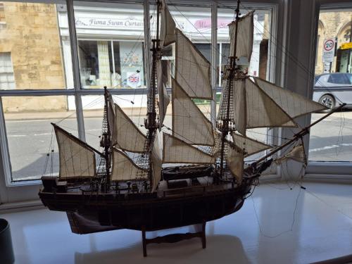a model of a boat on display in a room at The Ship Inn in Oundle