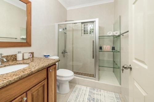a bathroom with a shower and a toilet and a sink at Fairview Near AC Hotel Kingston - FIWI in Kingston