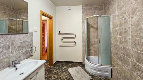 a bathroom with a shower and a sink at Guest house Sunrise in Šiauliai