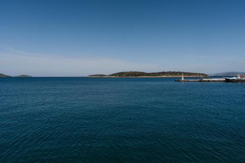 a large body of water with a pier in it at Seannamon Apartment with sea view by 8essentially in Agios Nikolaos