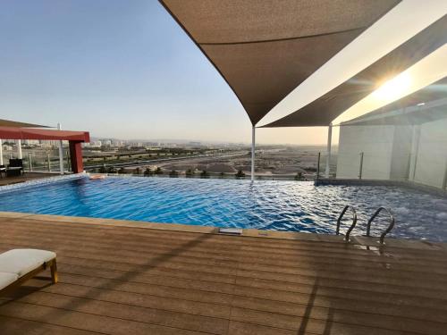 a large swimming pool on top of a building at Carnelian Muscat - Airport Hotel in Muscat