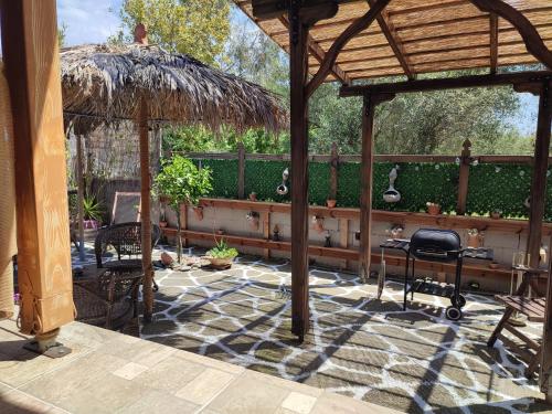 a pavilion with a table and chairs on a patio at Bohem House in Asprovalta