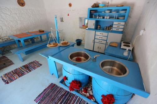 a blue counter with a sink in a room at Dalmatian rustic house in Petrcane