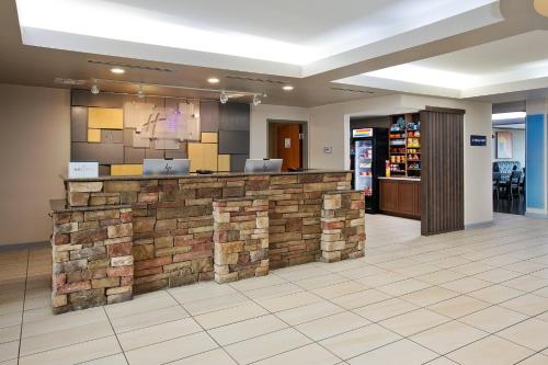 a lobby with a stone counter in a store at Holiday Inn Express Hotel & Suites Auburn Hills by IHG in Auburn Hills