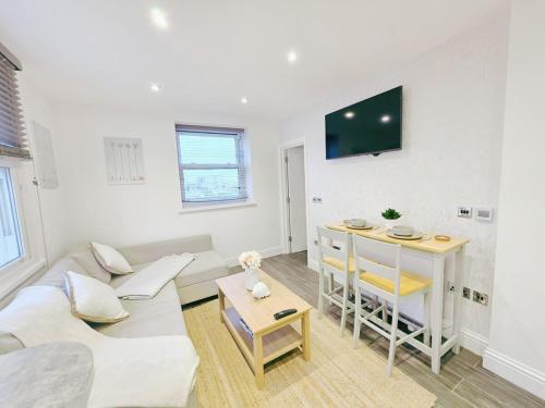 a living room with a couch and a table at Cosy 1 Bed Home, City Centre, Long & Short Stays in Brighton & Hove